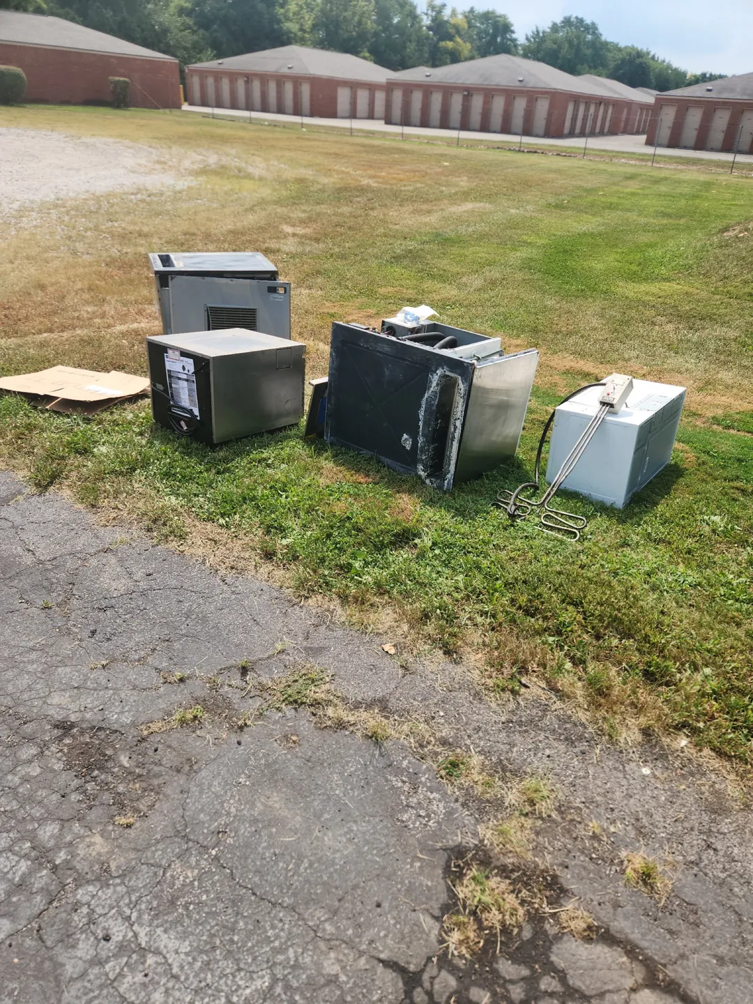 Stainless steel appliances and mixed metal items set out for an Indy Pickup 1111 cleanout