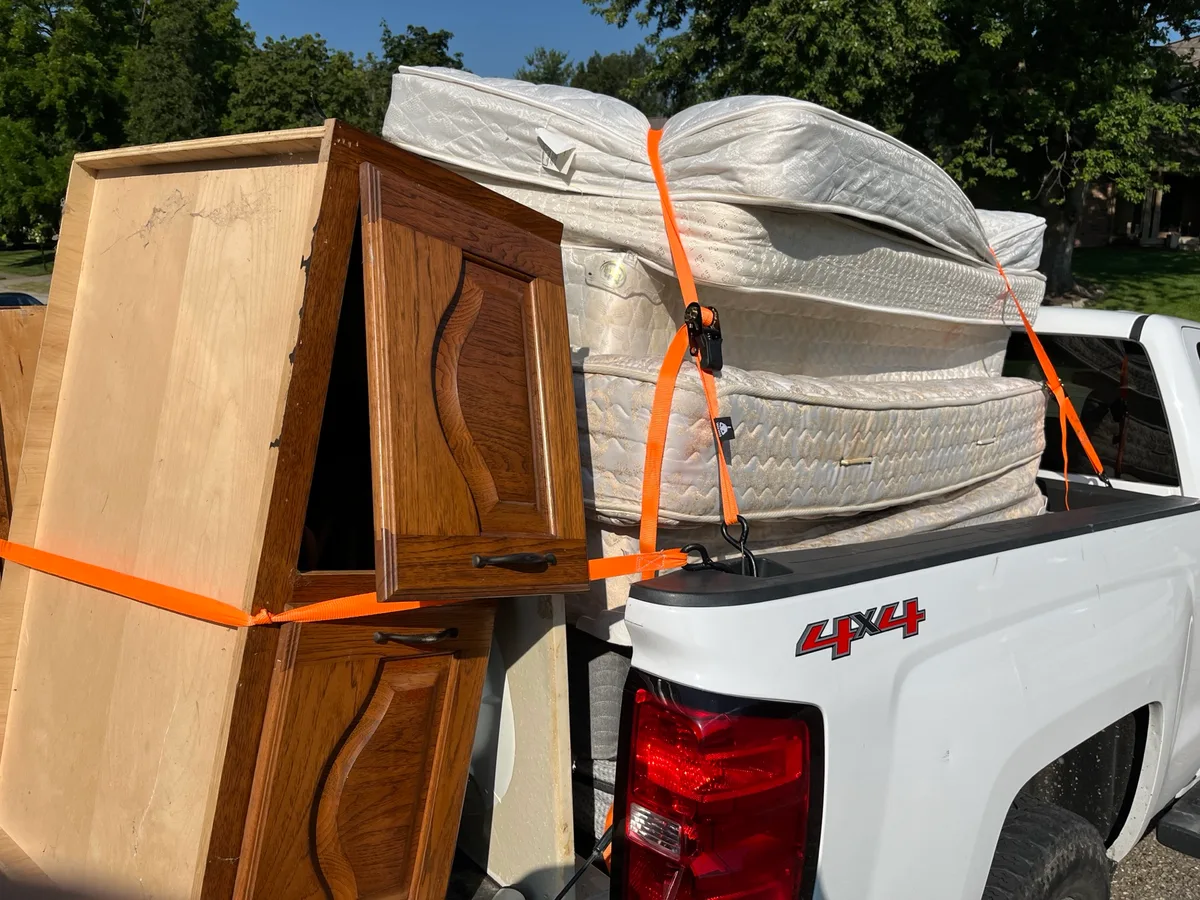 Surcharge items from a spring declutter -- mattresses and old cabinets -- strapped down for one Indy Pickup 1111 stop