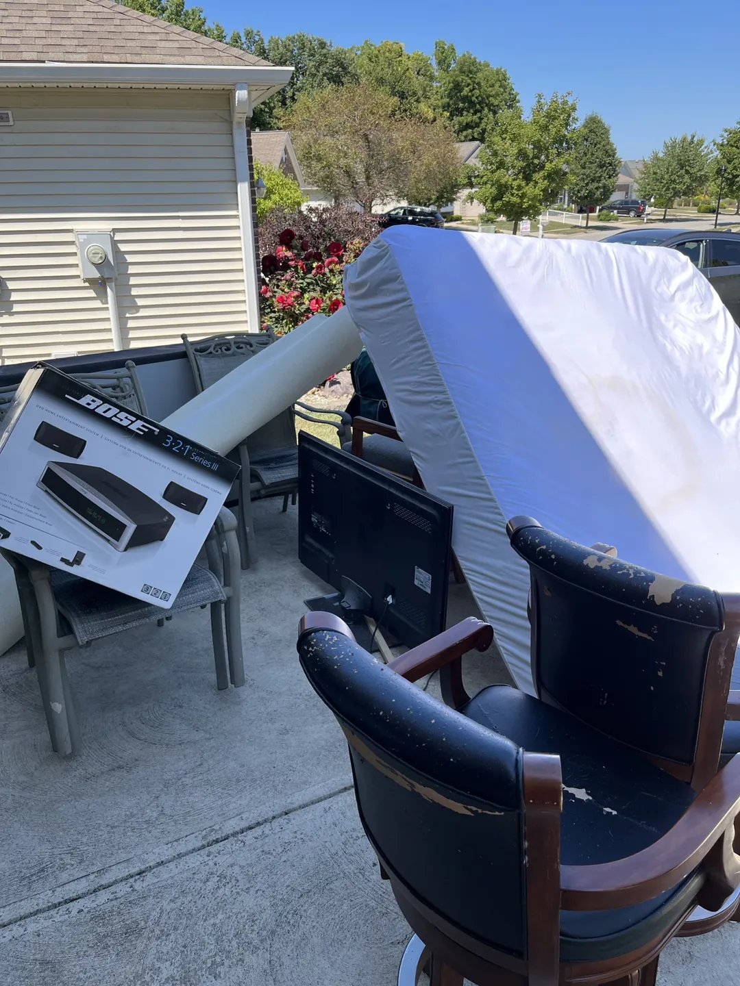 Scrap metal recycling pickup in Indianapolis -- old appliances and metal items staged on a driveway for Indy Pickup 1111