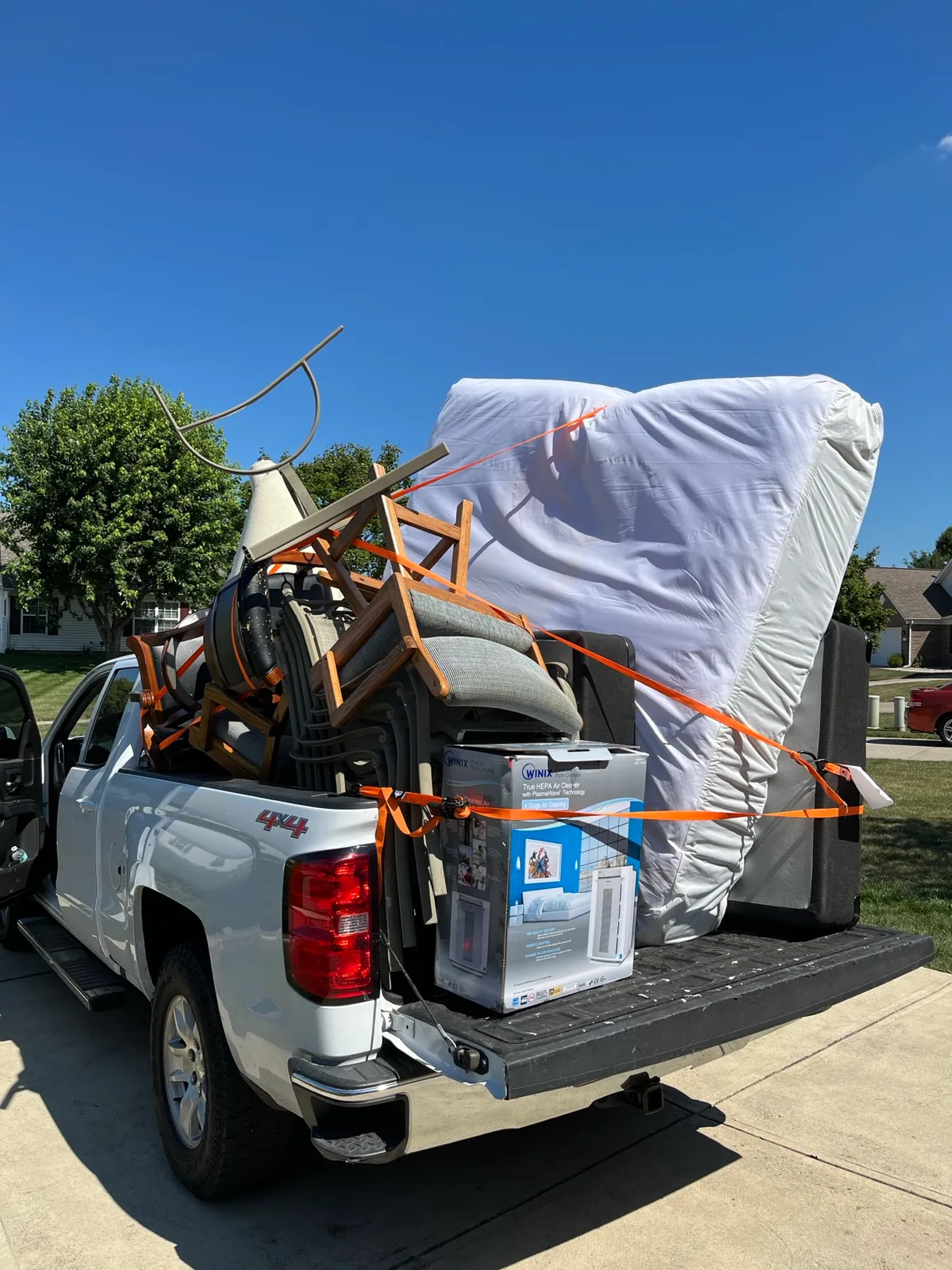 Pickup truck bed packed with metal and household items after an Indianapolis removal job