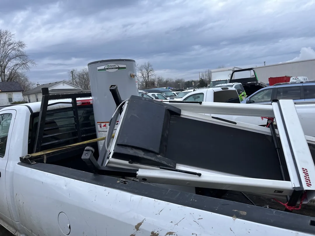 Used water heater secured on a pickup truck for recycling in Indianapolis